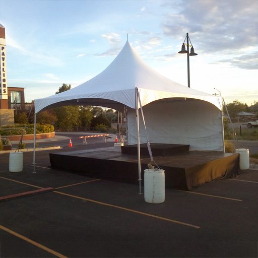 4' x 8 panel staging outdoors under a tent with no walls on three sides