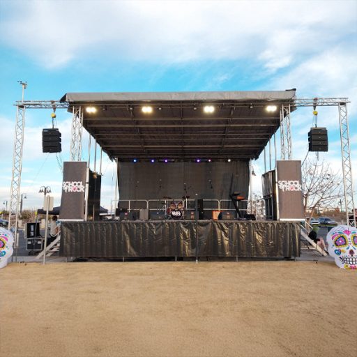 Empty stage with digital screen and speakers in a desert durig a sunny day
